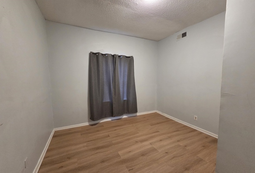 Spare room with light wood-style floors and a textured ceiling