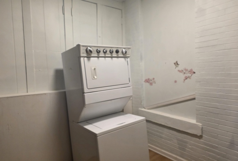 Laundry area with stacked washer and dryer