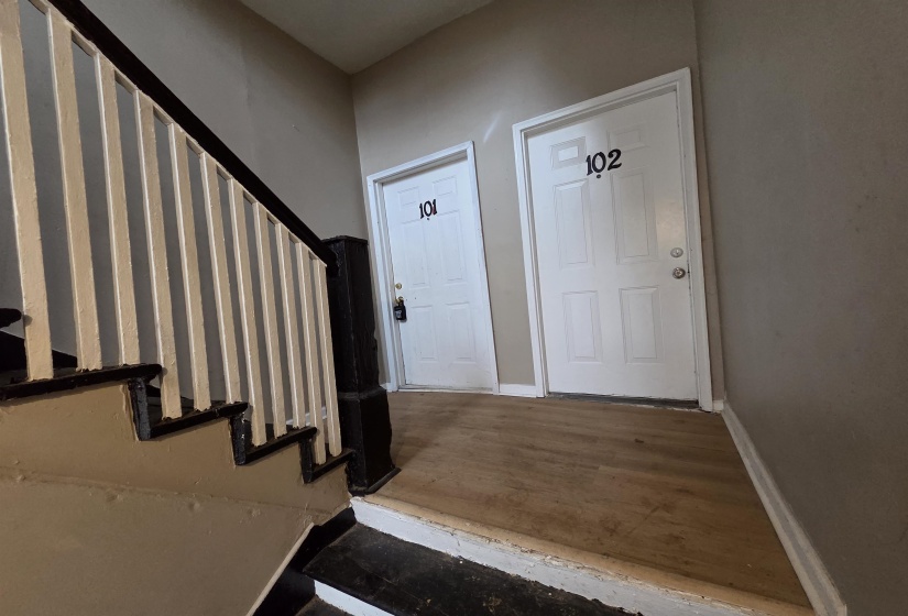 Foyer entrance featuring stairway and wood finished floors
