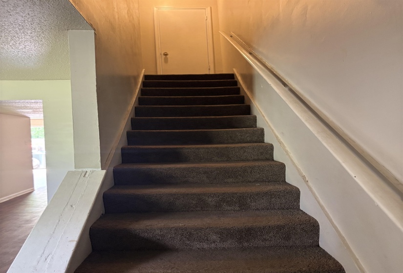 Stairs with a textured ceiling