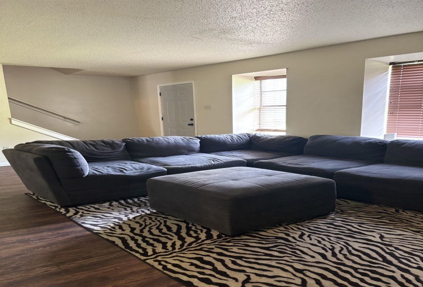 Living room featuring wood finished floors and a textured ceiling
