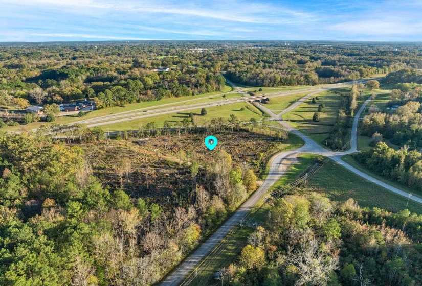 Aerial overview of property's location featuring a forest