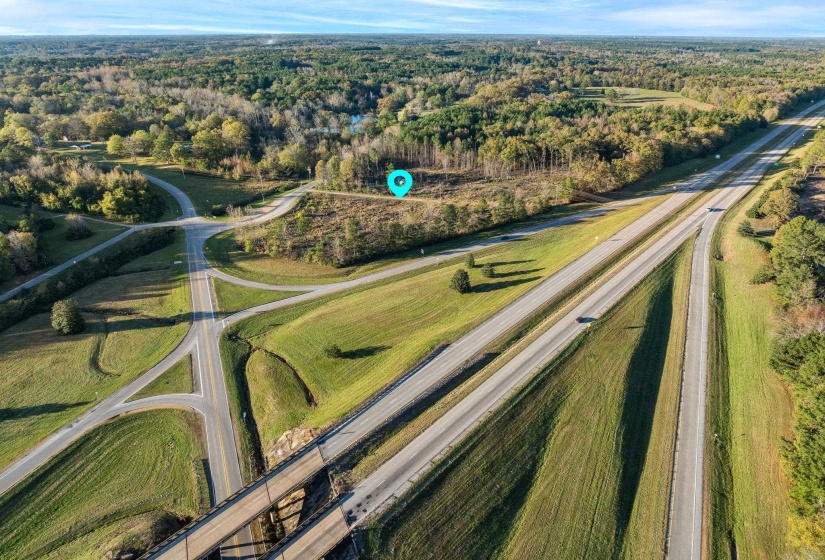 Aerial overview of property's location featuring a forest
