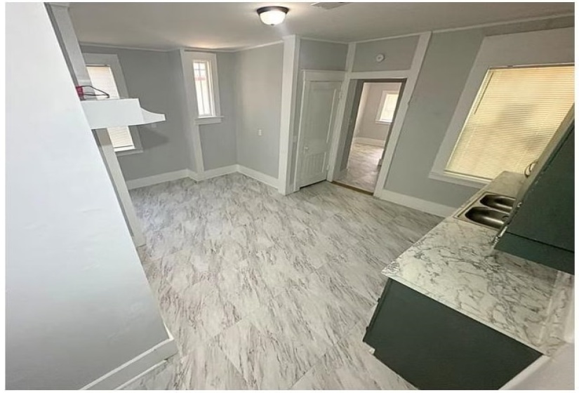 Corridor with baseboards and light wood-style floors