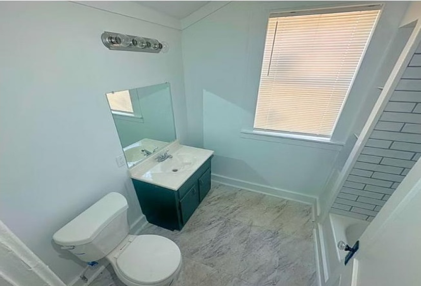 Full bathroom featuring baseboards and vanity