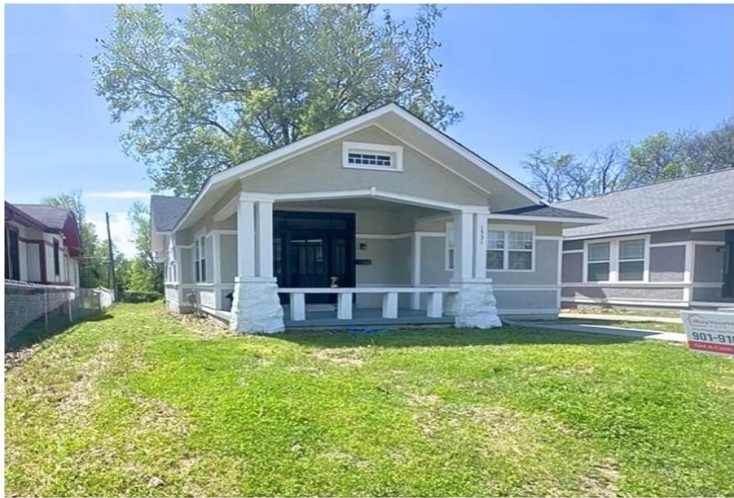 View of front of house featuring a sunroom and a front yard