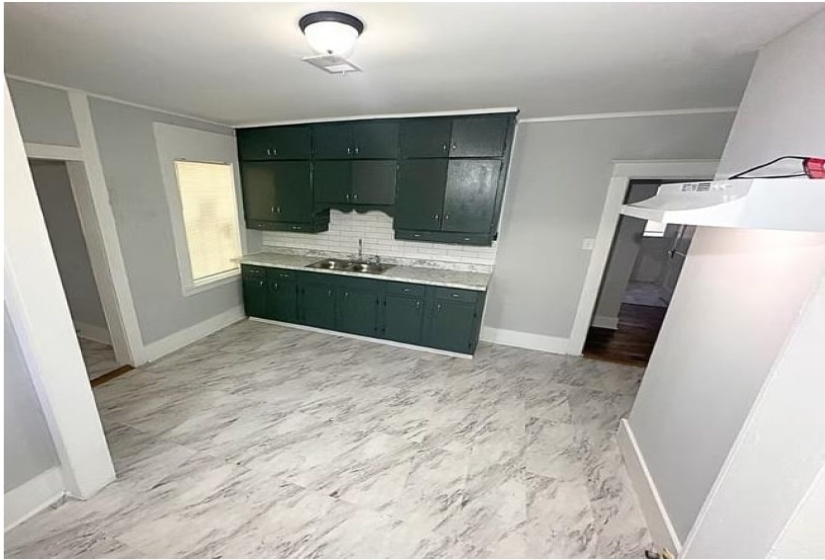Bathroom with vanity and tasteful backsplash