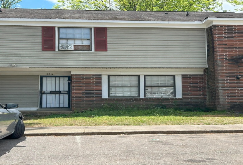 View of property exterior with brick siding