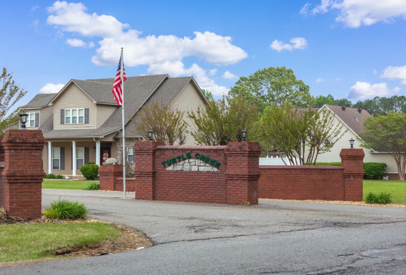 View of front of property featuring a shingled roof and covered porch