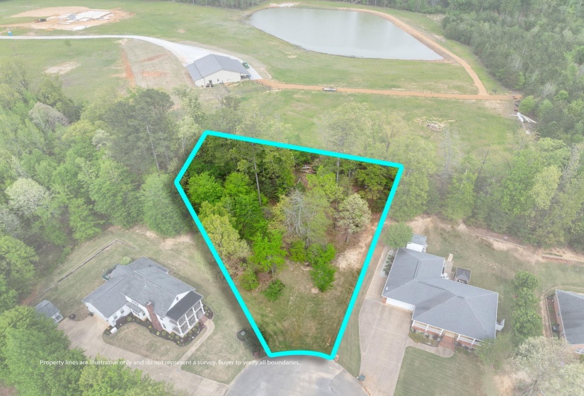 Aerial view of property and surrounding area featuring a large body of water and property parcel outlined