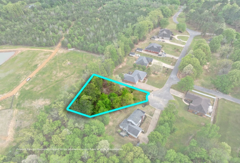 Aerial overview of property's location featuring property parcel outlined and a heavily wooded area