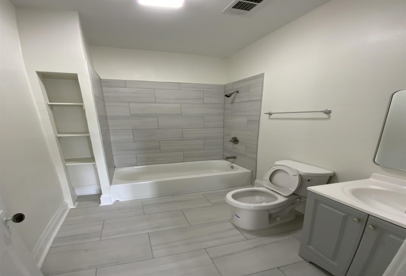 Bathroom with vanity and shower / tub combination