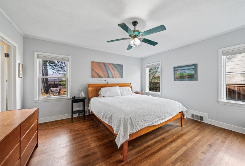 Bedroom with hardwood / wood-style floors and a ceiling fan