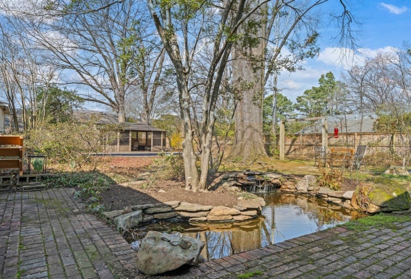 View of yard featuring a small pond, a gazebo, a patio, and a pool