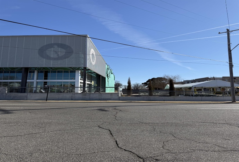 View of asphalt road with curbs and sidewalks