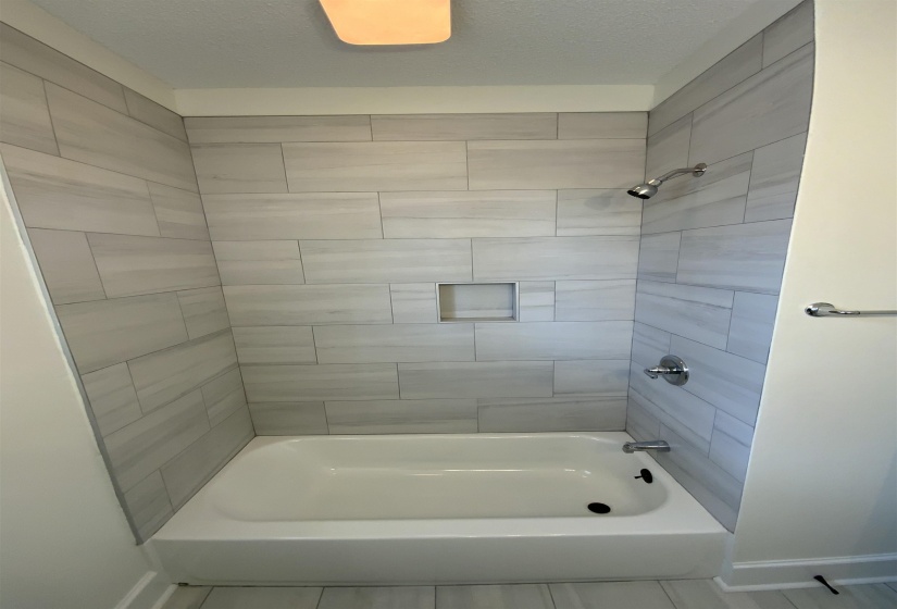 Full bathroom featuring shower / bathtub combination and baseboards