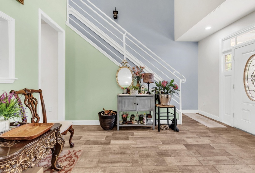 Entrance foyer with wood finished floors and recessed lighting