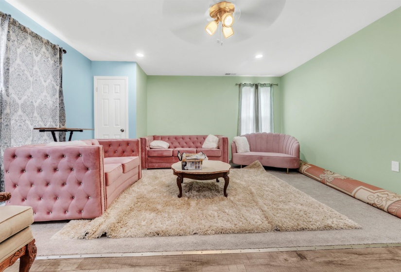 Living room with ceiling fan and recessed lighting