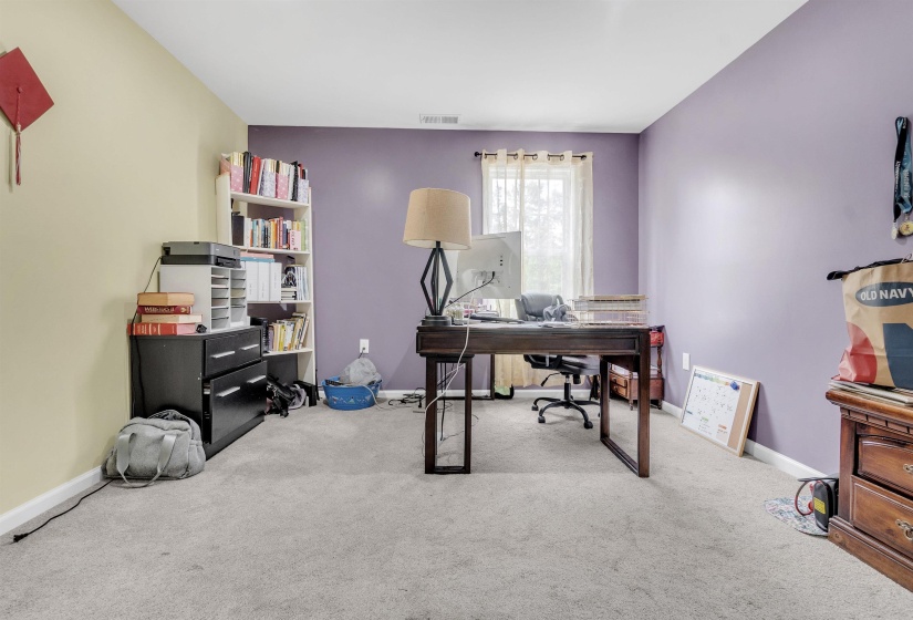Home office with light carpet and baseboards