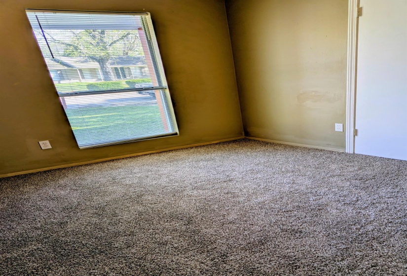 Carpeted empty room with baseboards