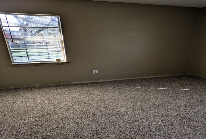 Carpeted bedroom featuring baseboards