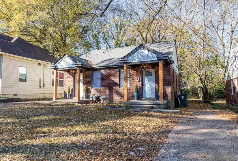 Bungalow-style house with brick siding and a front yard