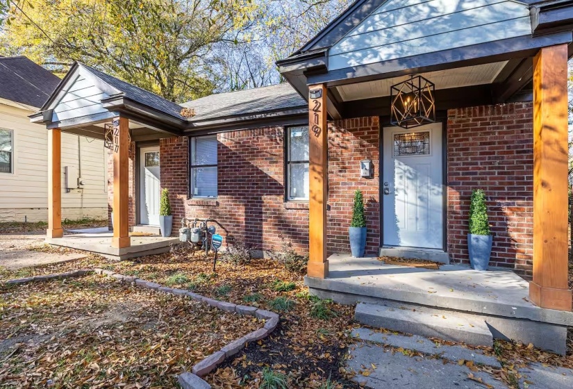 Entrance to property featuring brick siding