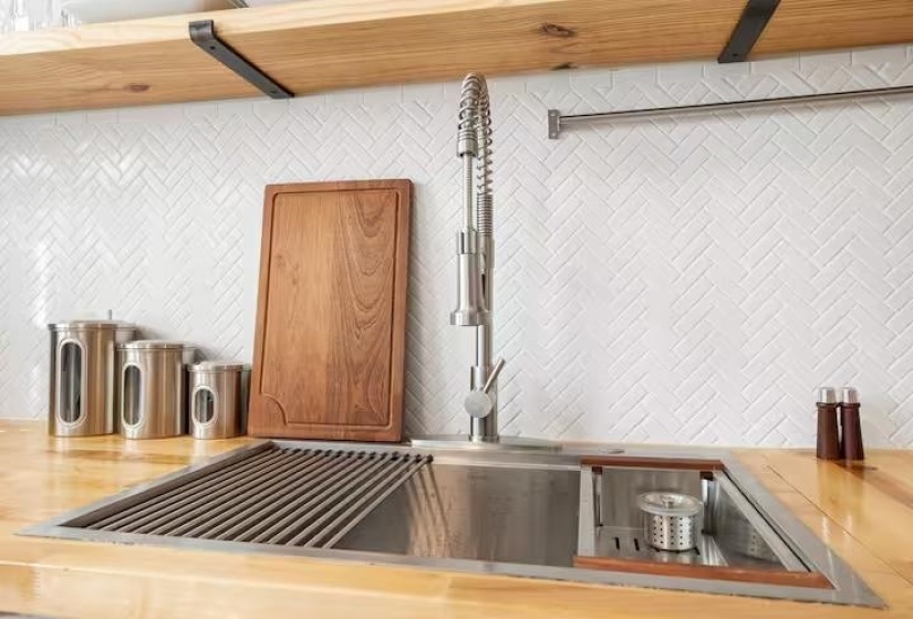 Kitchen view of a sink and butcher block counters