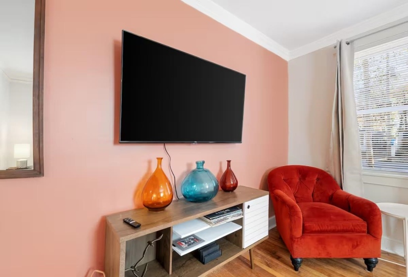 Living area featuring ornamental molding and wood finished floors