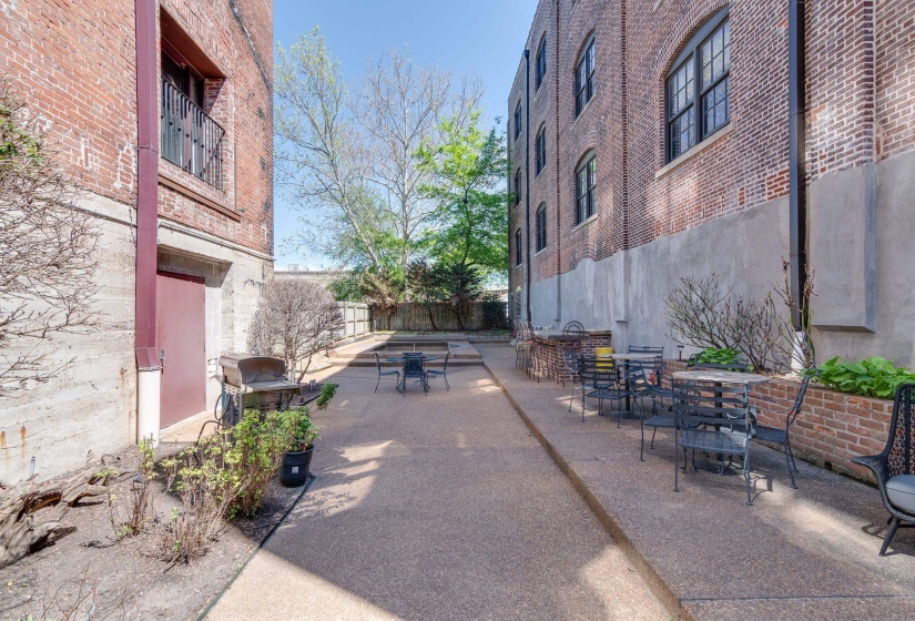 View of patio with outdoor dining area and a grill