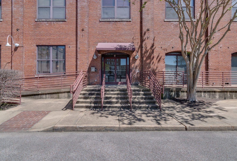 View of exterior entry with french doors and brick siding