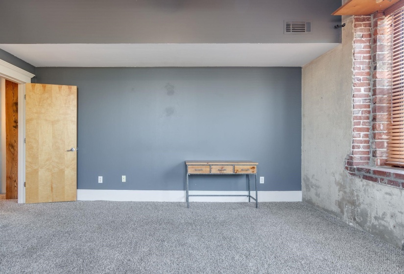 Spare room featuring carpet flooring and baseboards