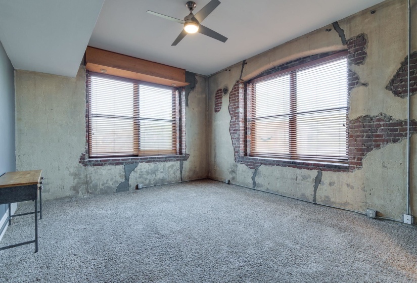 Unfurnished room with a ceiling fan and carpet flooring