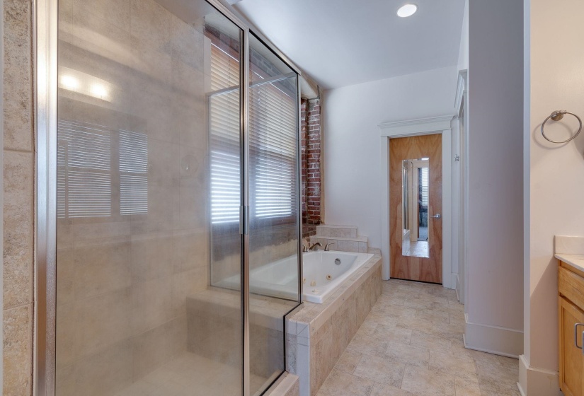Bathroom with vanity, a whirlpool tub, a stall shower, and recessed lighting