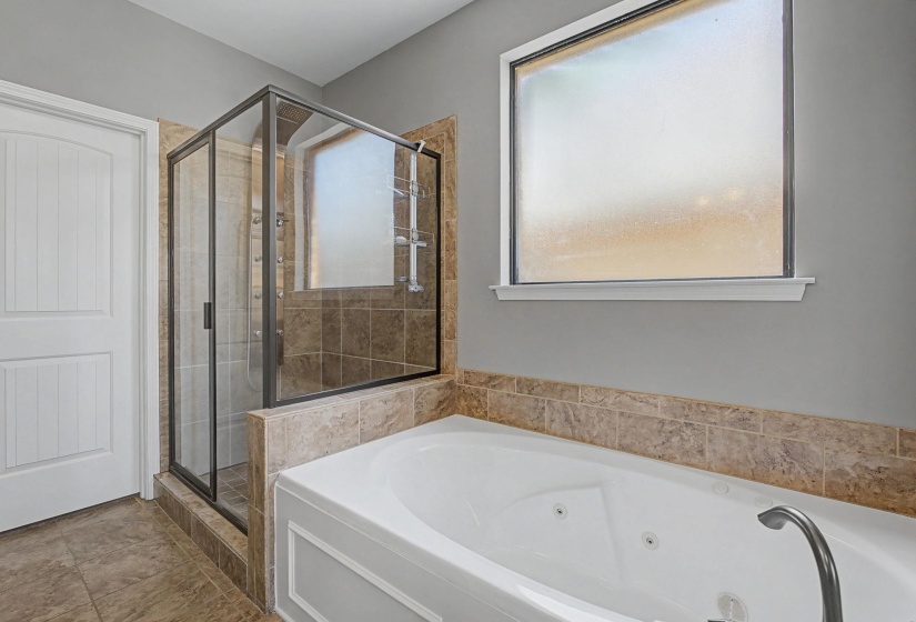 Full bathroom with a stall shower and a whirlpool tub