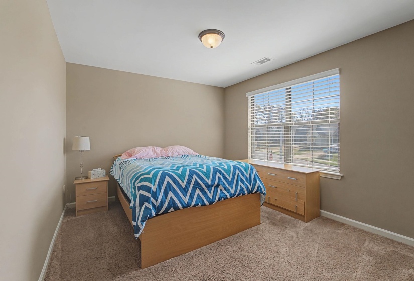 Carpeted bedroom with baseboards