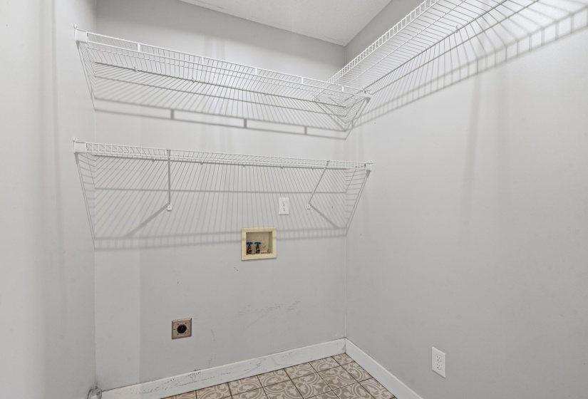 Laundry room featuring washer hookup, electric dryer hookup, and light flooring