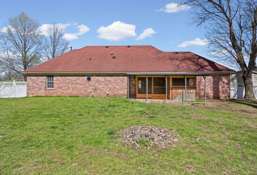 Rear view of house with a sunroom, brick siding, and a shingled roof