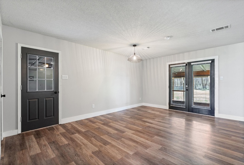 Breaksfast area featuring a textured ceiling, french doors, and dark wood finished floors
