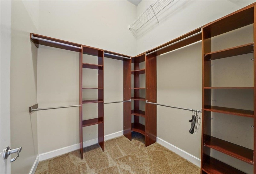 Huge walk-in closet with ample hanging and folded storage. 11' ceilings in closet