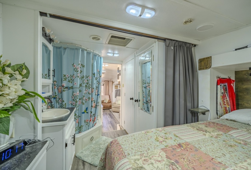 Bedroom featuring a sink and wood finished floors