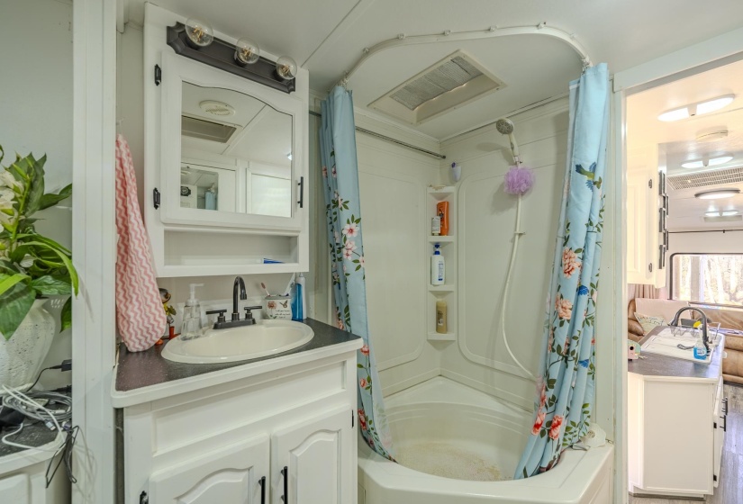 Bathroom featuring vanity and shower / tub combo