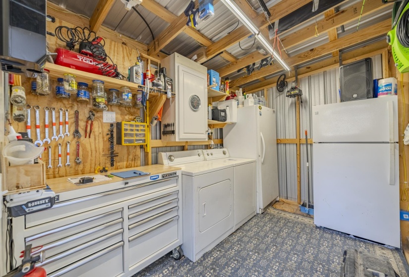 Laundry room featuring washing machine and clothes dryer and dark flooring