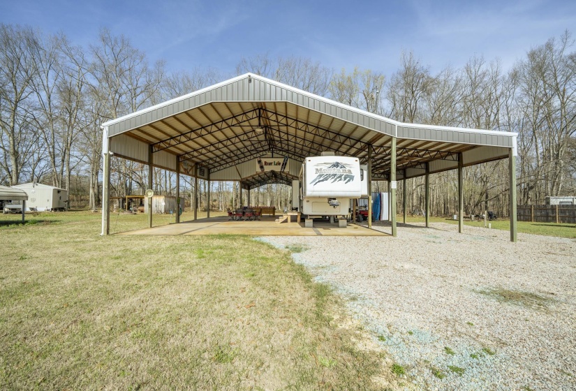 View of parking with a detached carport