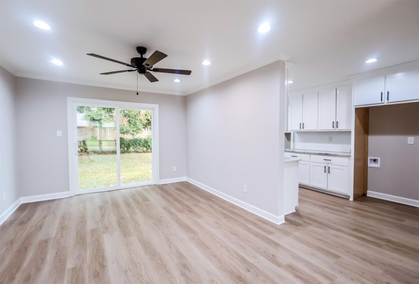 Unfurnished living room with light wood-style flooring, a ceiling fan, ornamental molding, and recessed lighting