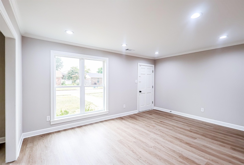 Unfurnished room with crown molding, light wood-style flooring, and recessed lighting