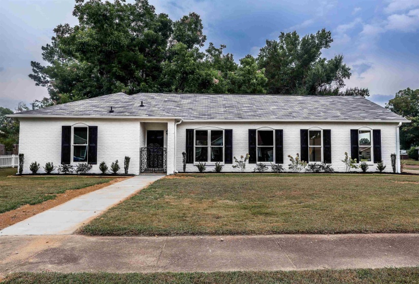Single story home with brick siding and a front lawn