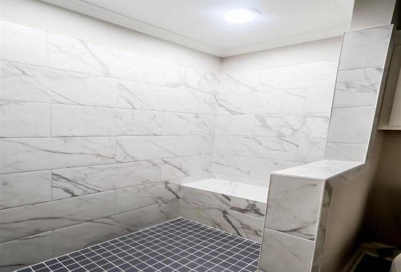 Full bath featuring a tile shower