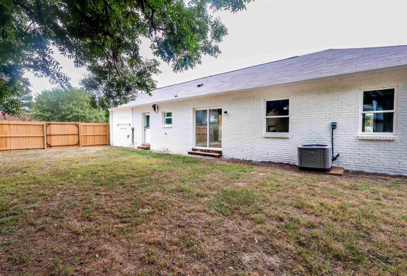 Back of property featuring brick siding and entry steps