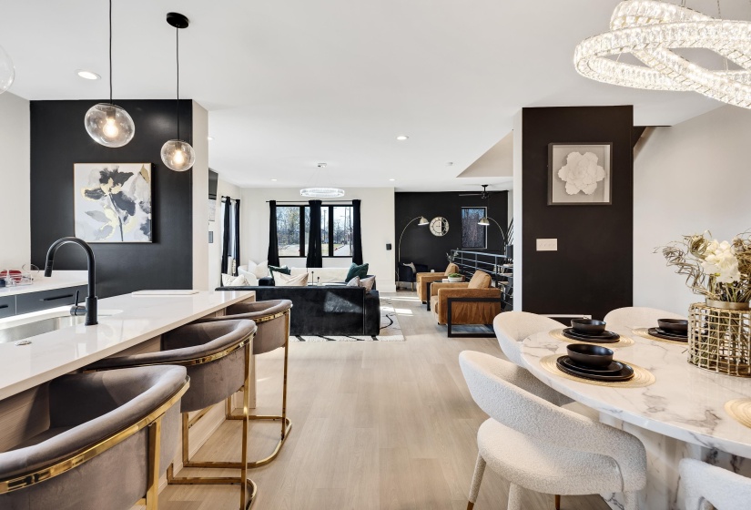 Dining area with light wood-style flooring, recessed lighting, a chandelier, and an accent wall
